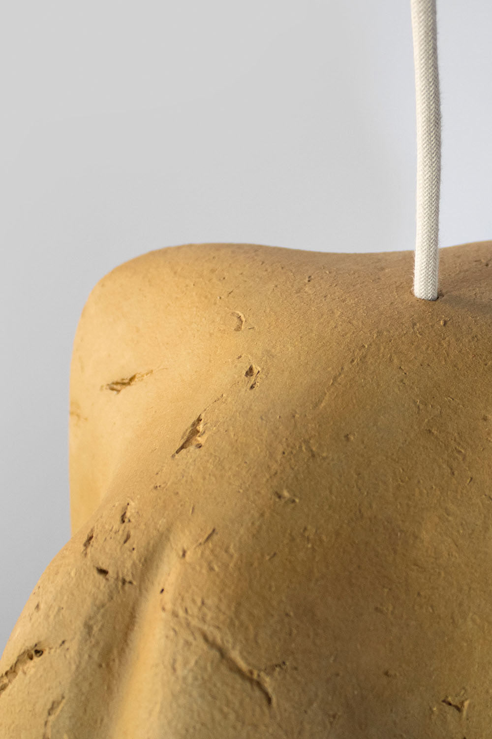 detail of paper mache yellow pendant lamp