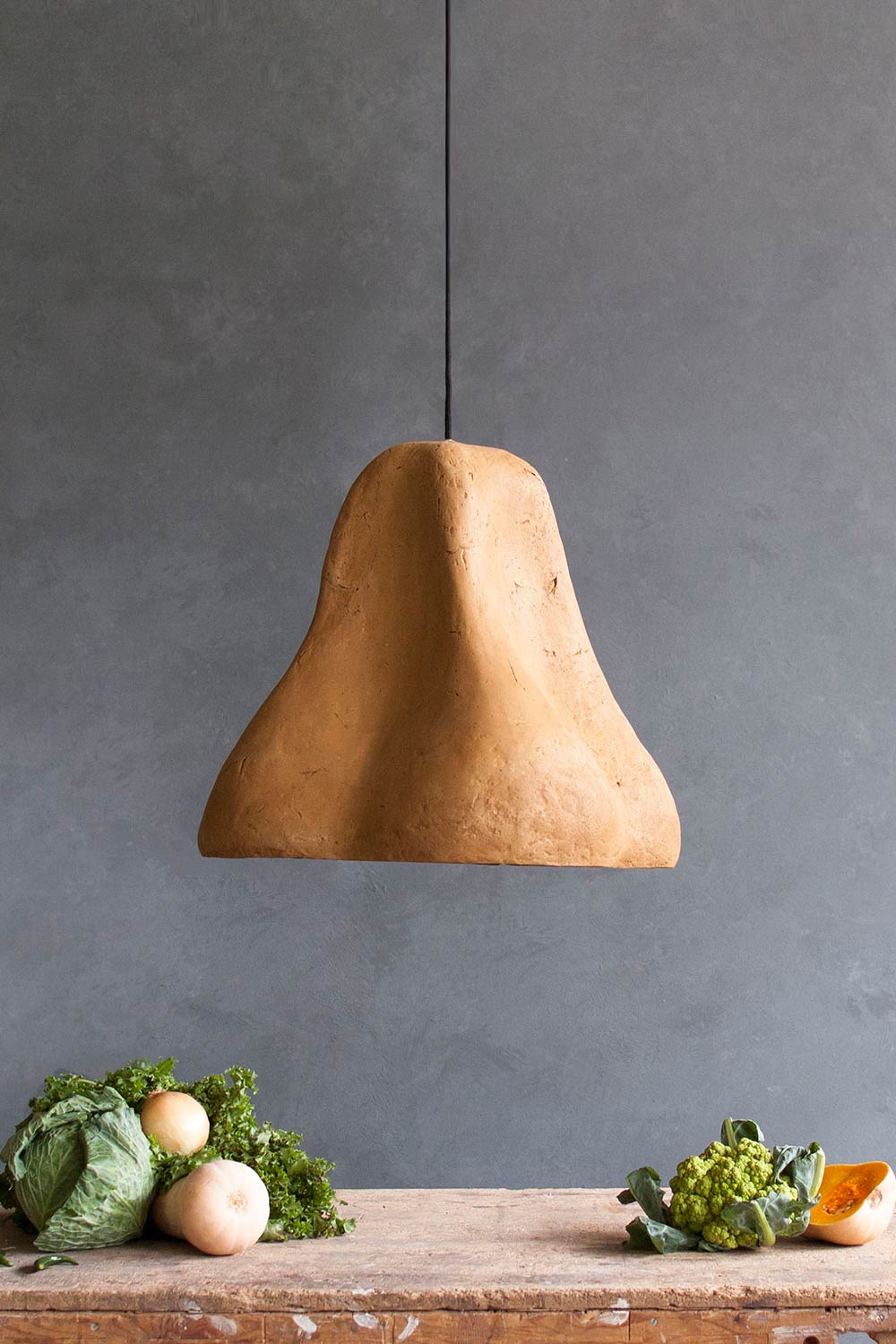 yellow art light sensi above the dining table with vegatables
