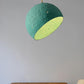 hanging lamp globe made of paper mache above the table with watermelon