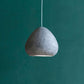 grey light fixture morphe above the table with a green apple