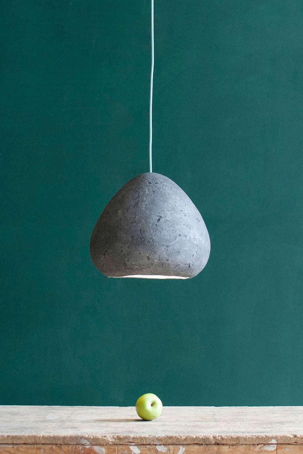 grey light fixture morphe above the table with a green apple