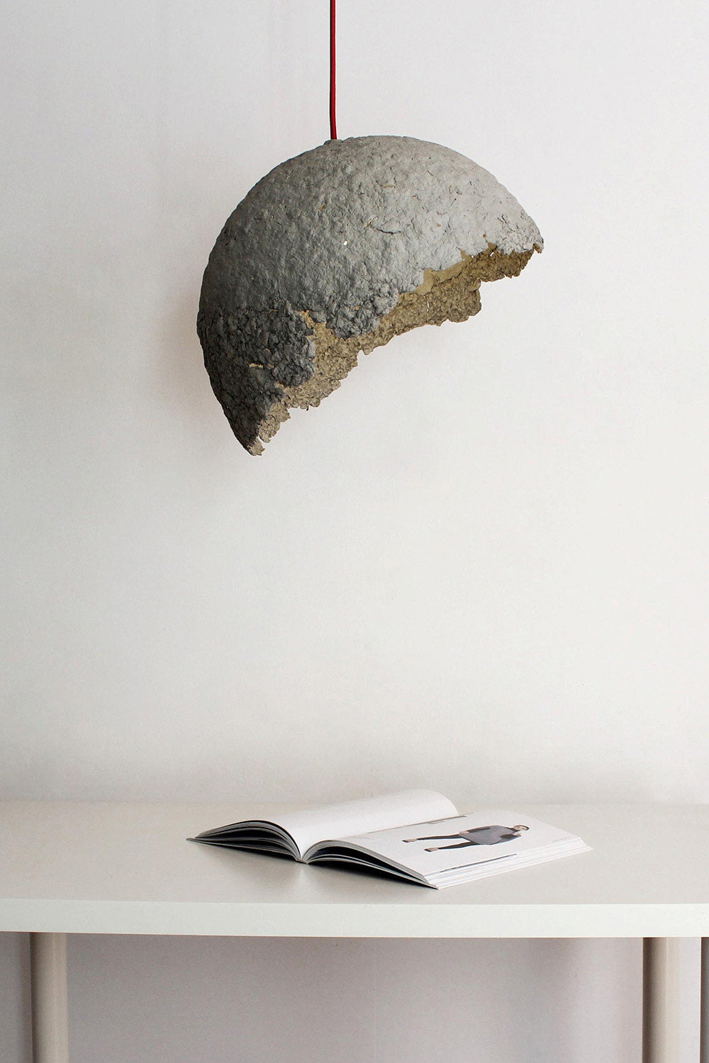 grey paper lamp globe rustic above the table with a book on it