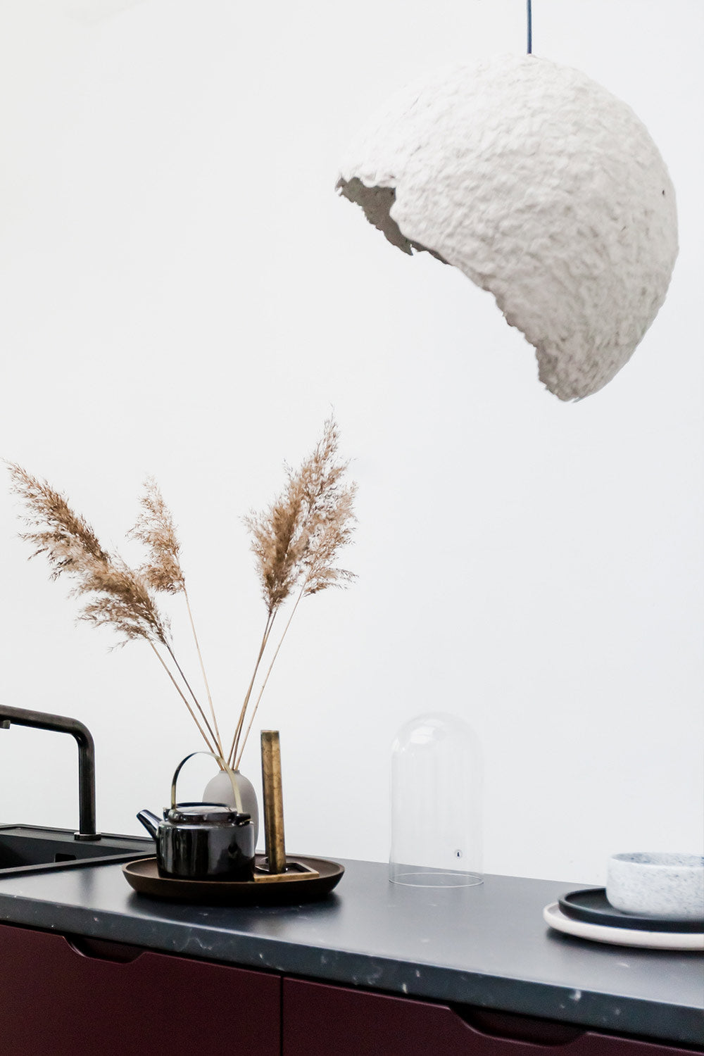 grey paper lamp globe above the kitchen island