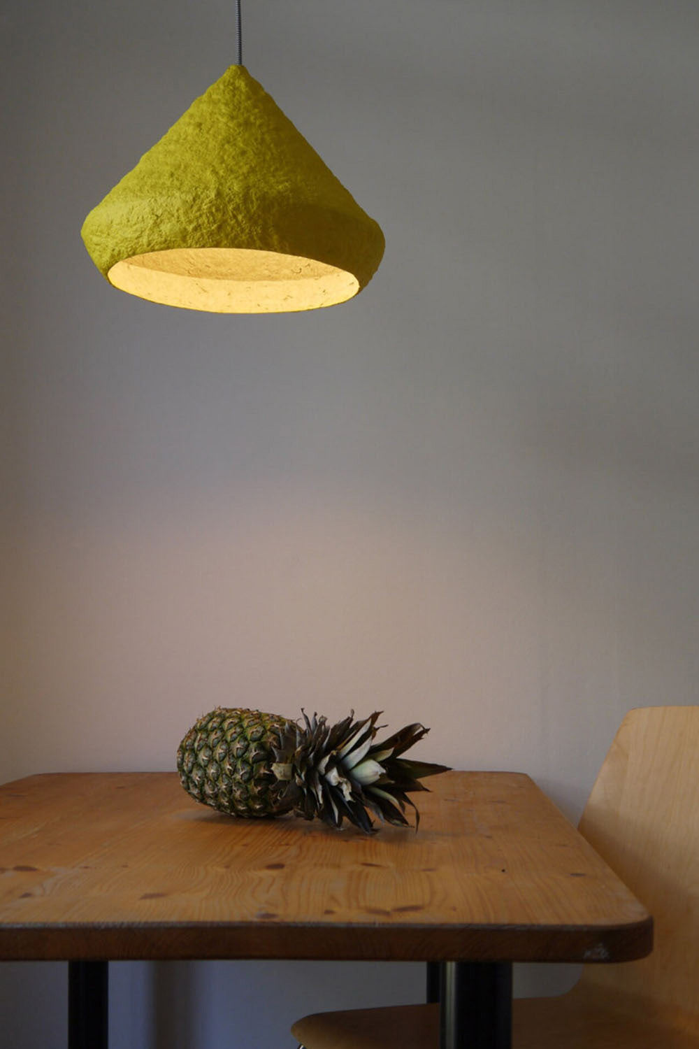 yellow paper mache lamp above the table