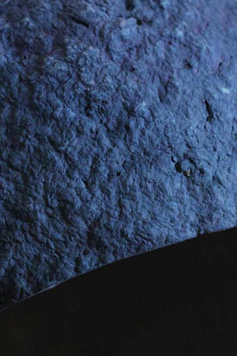 detail of texture of blue paper mache lamp pluto