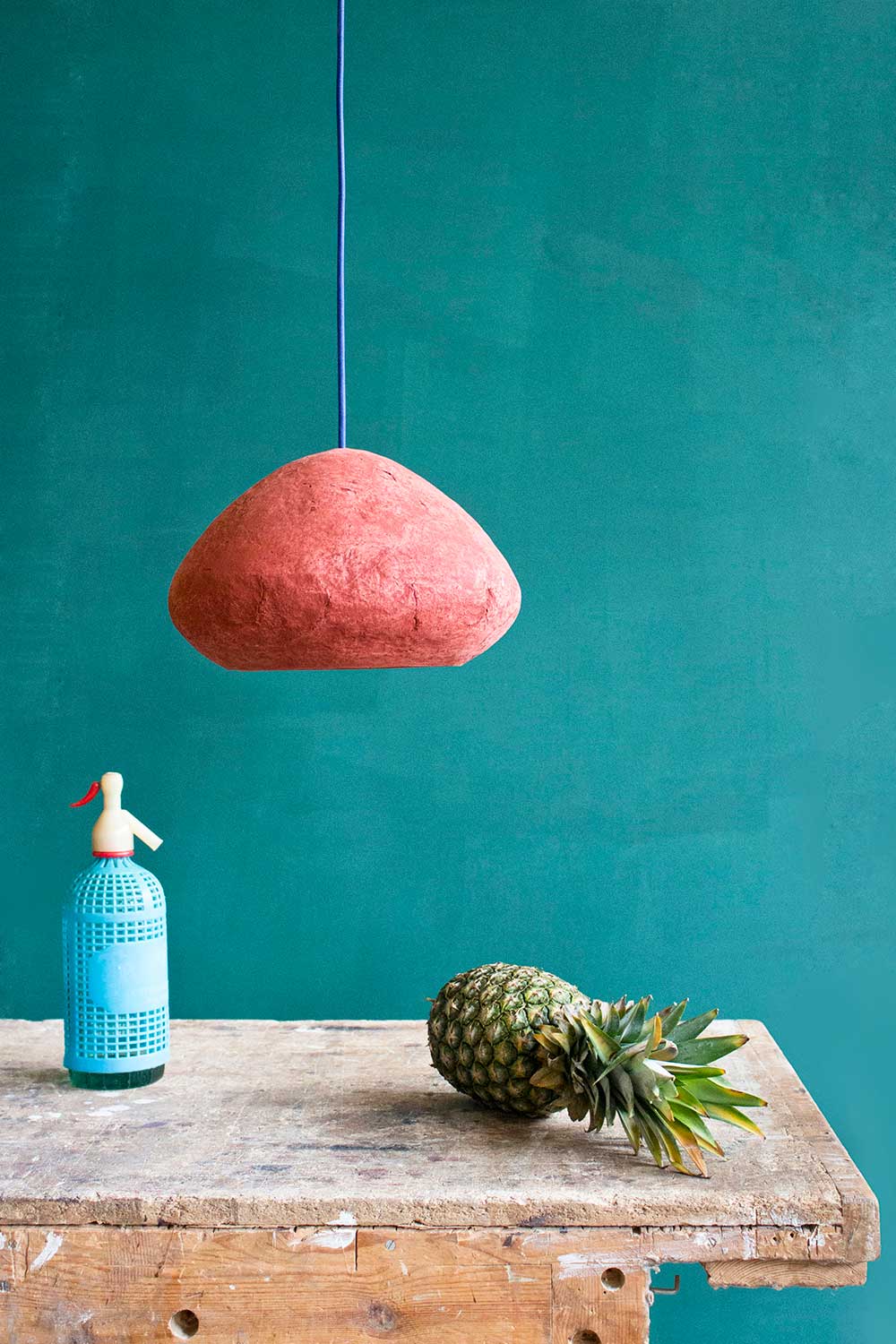 paper mache lamps morphe in red above the table