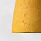 detail of the texture of yellow paper mache light conica