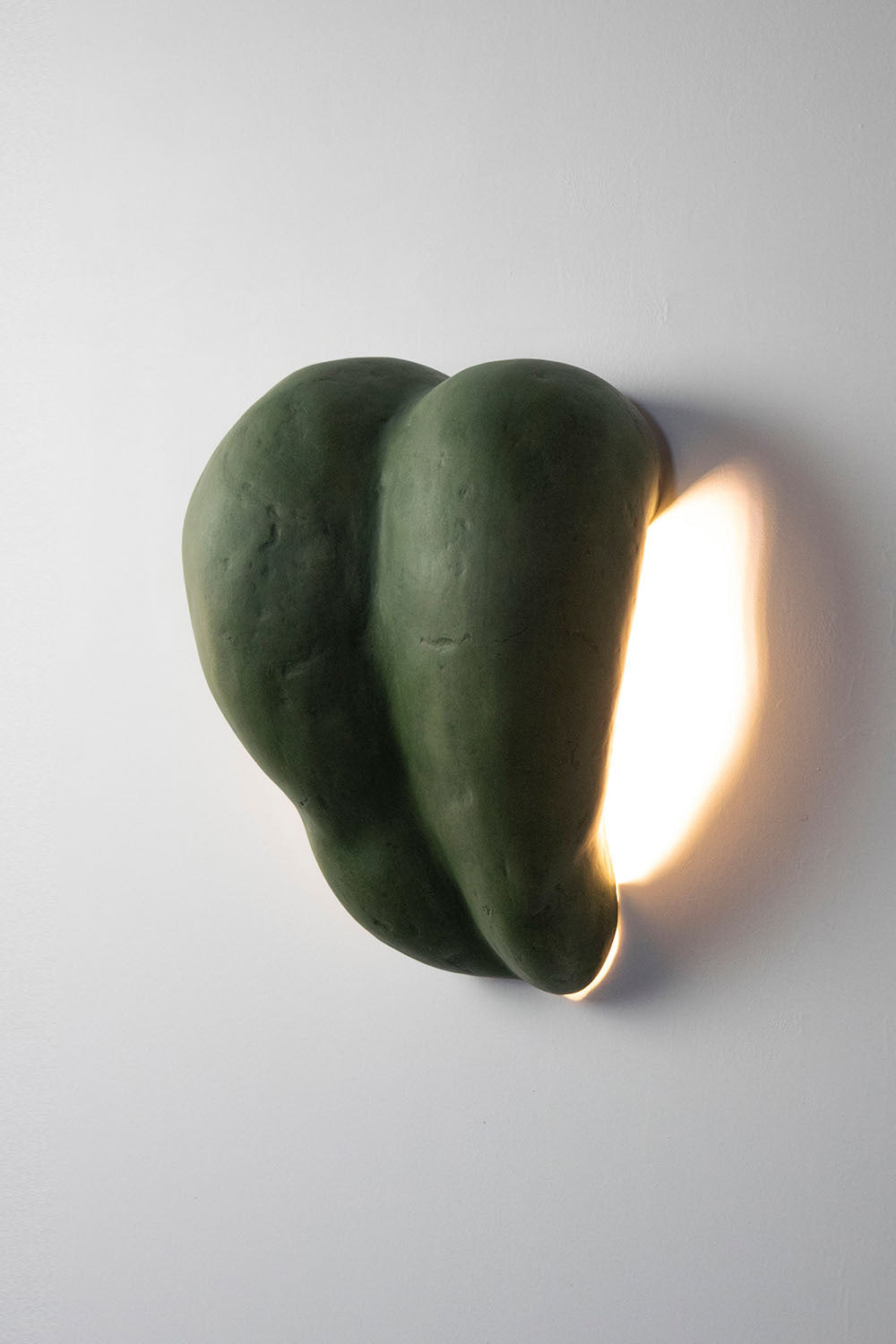 green sconce lamp made of paper mache