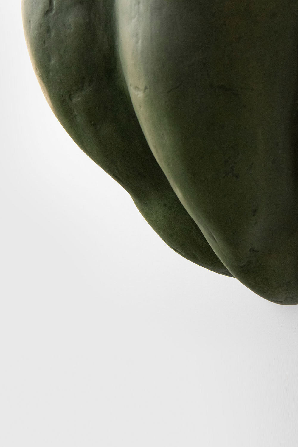 detail of organic sconce lamp in green made of paper mache